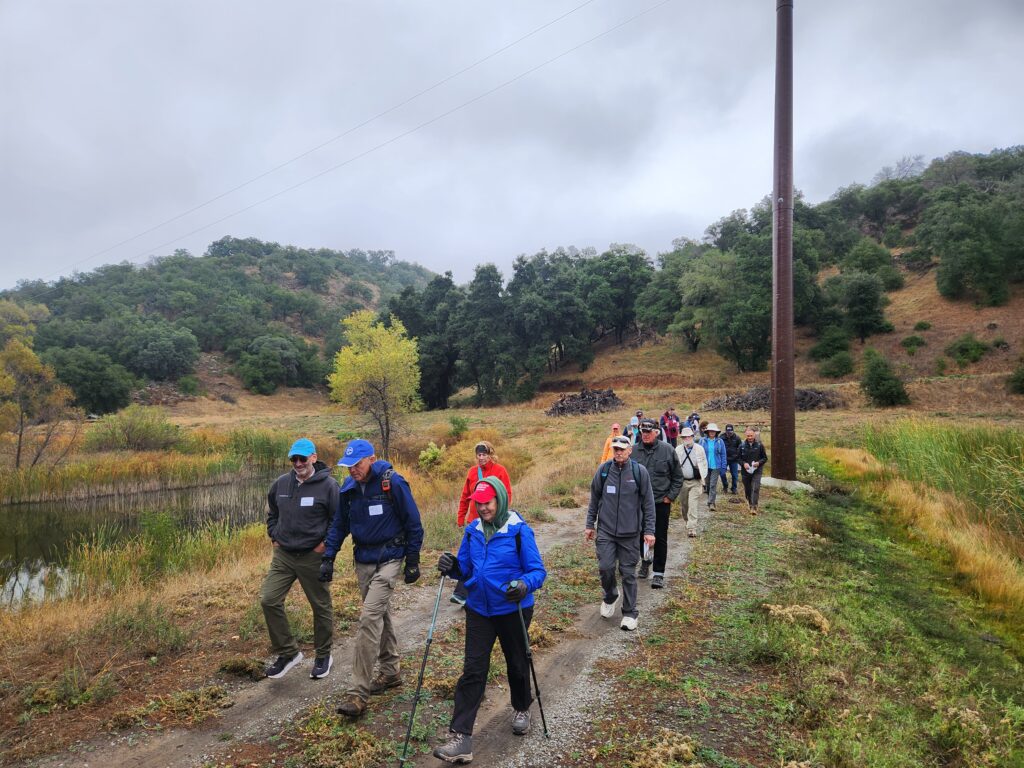 A group of hikers follow a trail in Eagle Peak Ranch