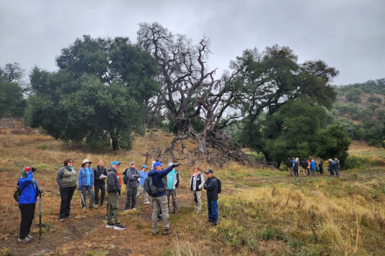 A group of hikers receive direction on the trail in Eagle Peak Ranch