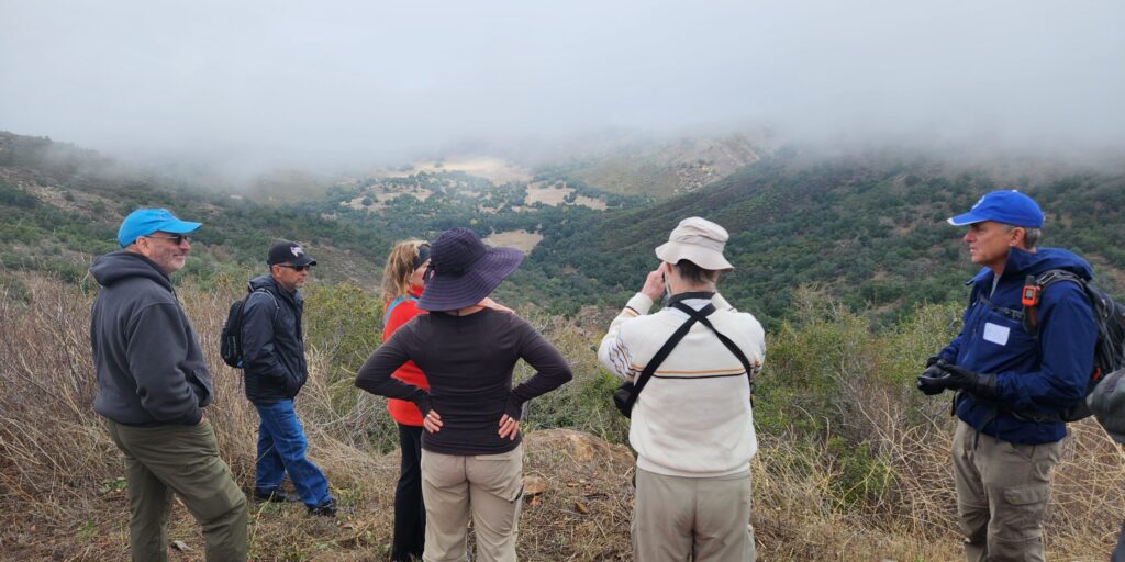Eagle Peak Ranch Preserve hike A group of hikers look out over a Vista at Eagle Peak Ranch Preserve