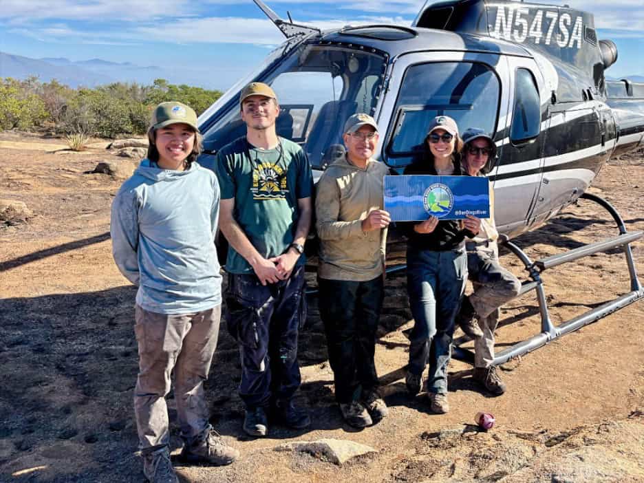 SDRPF staff and volunteers in front of helicopter that took them to the top of El caiptan Preserve to survey after the fire.