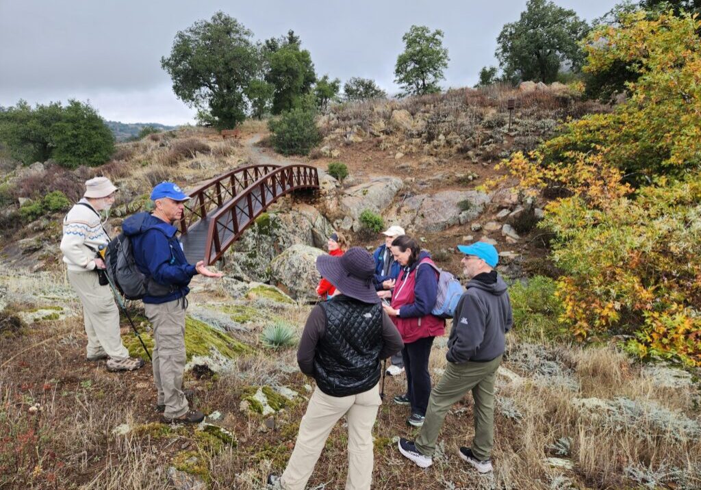 A group of hikers take a break near a bridge in Eagle Peak Ranch
