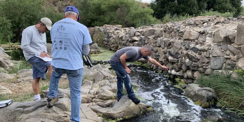 Water Quality Monitoring OldMissionDam Three men work together to measure the water quality of the River near the Old Mission Dam.